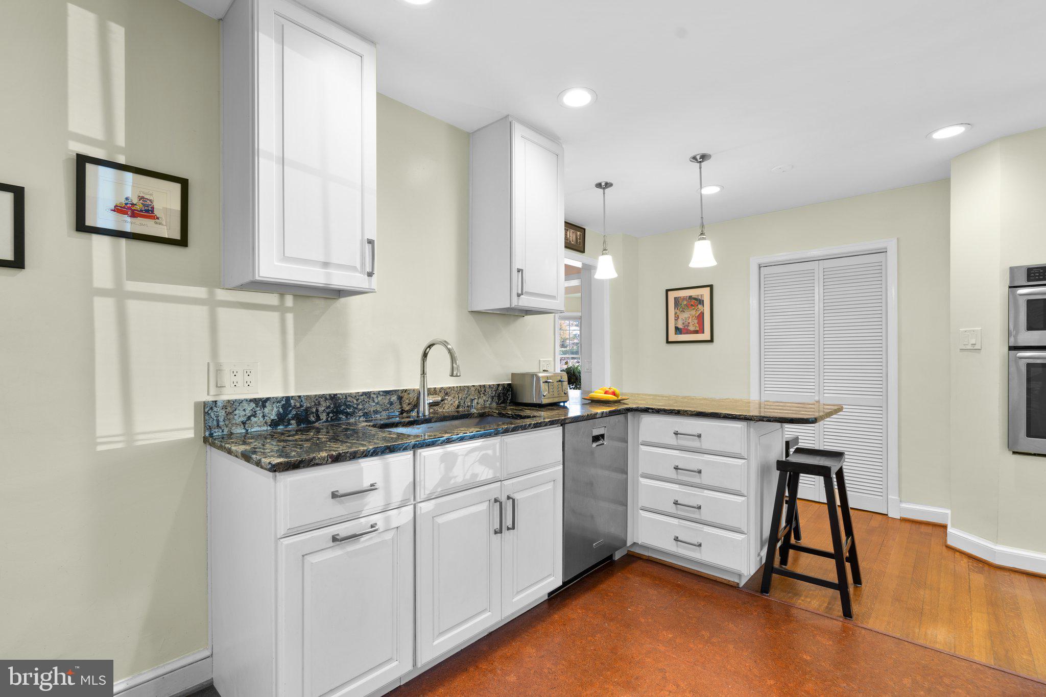 1616 Overlook Drive Silver Spring, MD 20903 - Photo 18 of 69 a kitchen with granite countertop white cabinets and white appliances