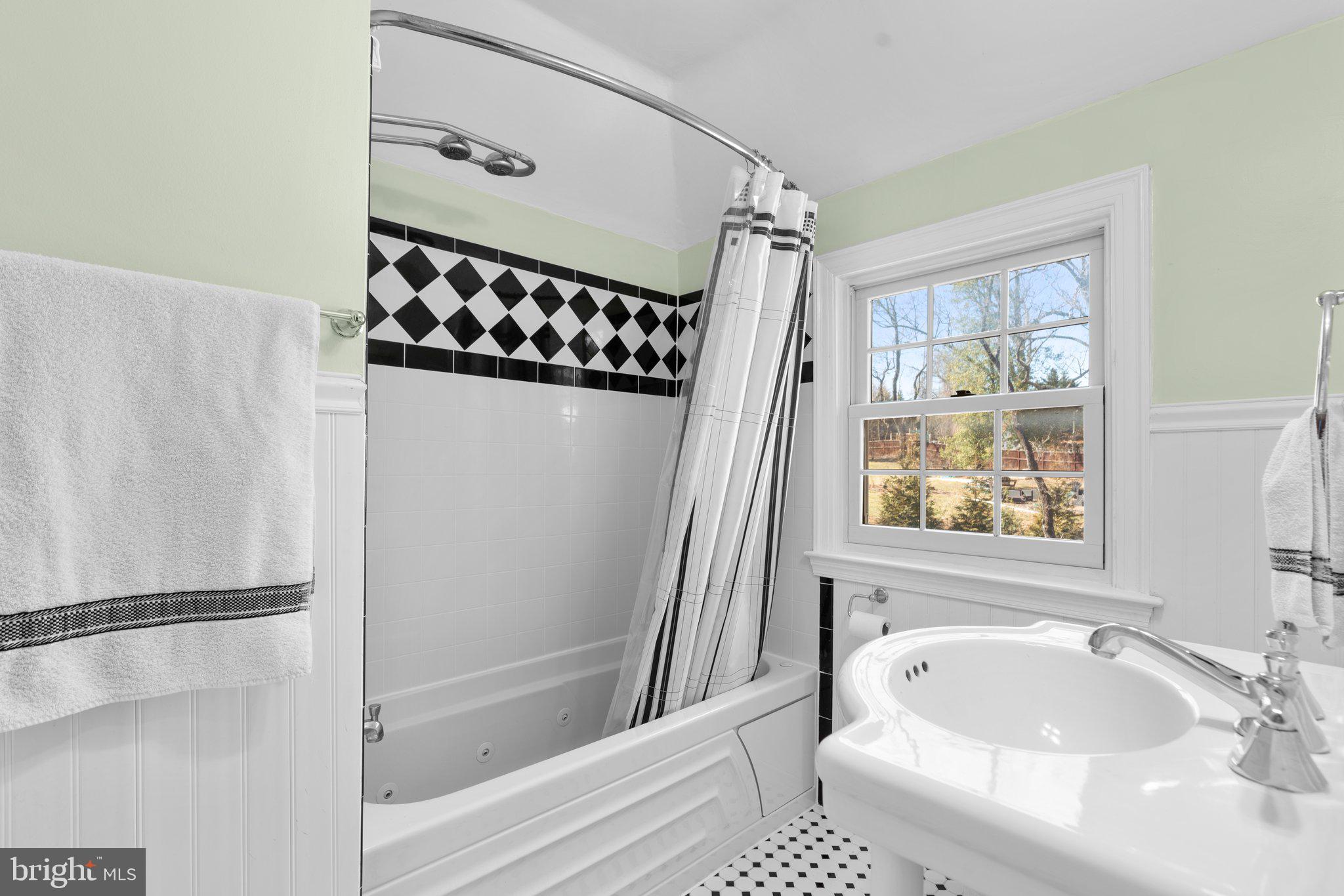 1616 Overlook Drive Silver Spring, MD 20903 - Photo 34 of 69 a bathroom with a tub a sink and a window