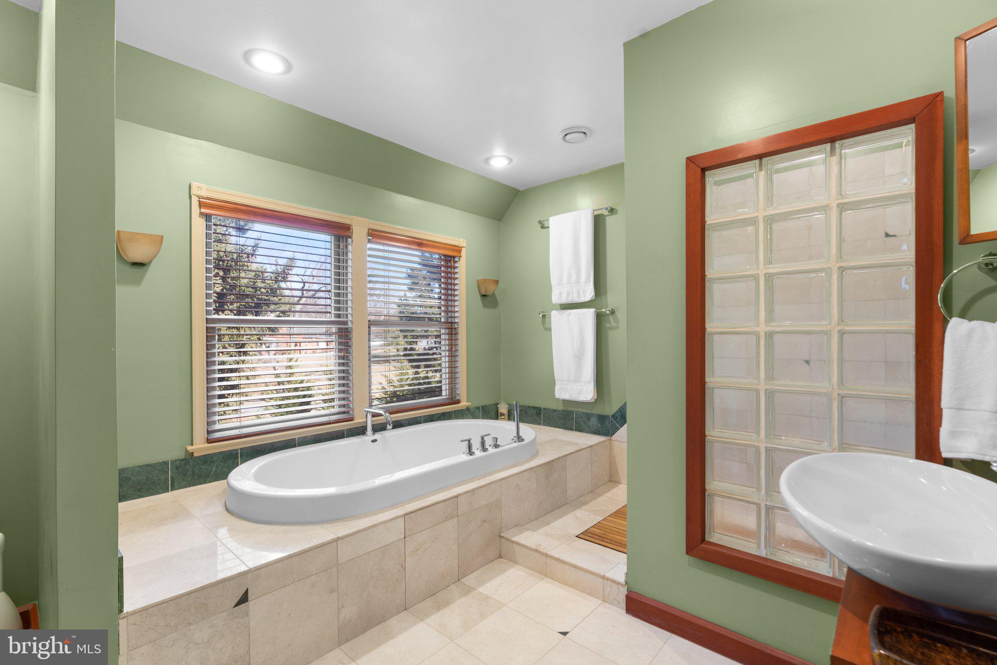 1616 Overlook Drive Silver Spring, MD 20903 - Photo 40 of 69 a spacious bathroom with a granite countertop tub and a sink