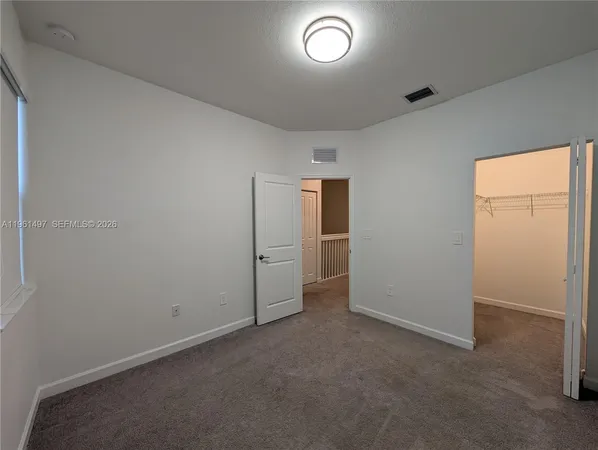 an empty room with closet area