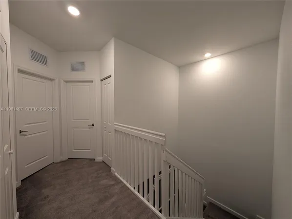 a view of hallway with wooden floor