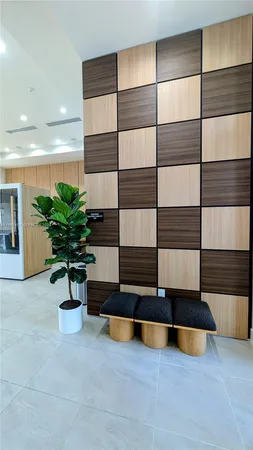 a living room with furniture cabinets and potted plant