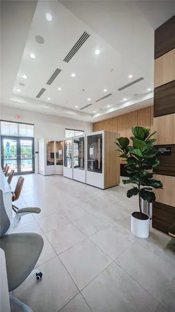 a lobby with furniture and potted plant