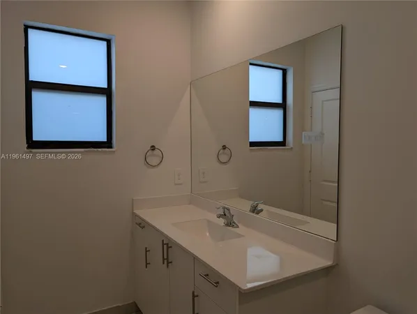 a bathroom with a sink a vanity and mirror