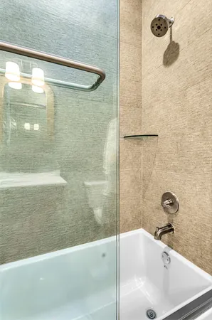 a view of a bathroom with a tub and mirror