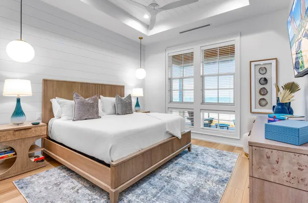 a bedroom with a bed and painting on the wall