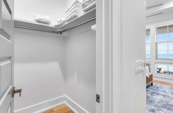 a bathroom with a granite countertop sink a toilet a mirror and shower