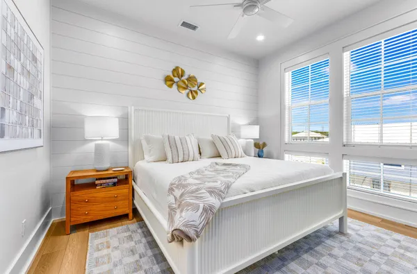 a terrace of a house with wooden floor outdoor seating and city view