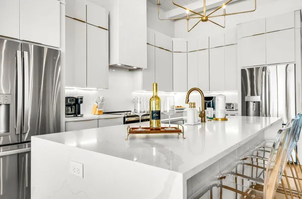 a view of hallway with a large window and wooden floor