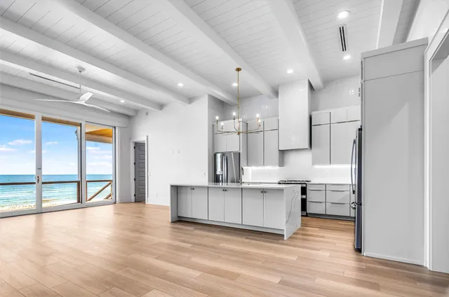 a view of kitchen with cabinets and wooden floor