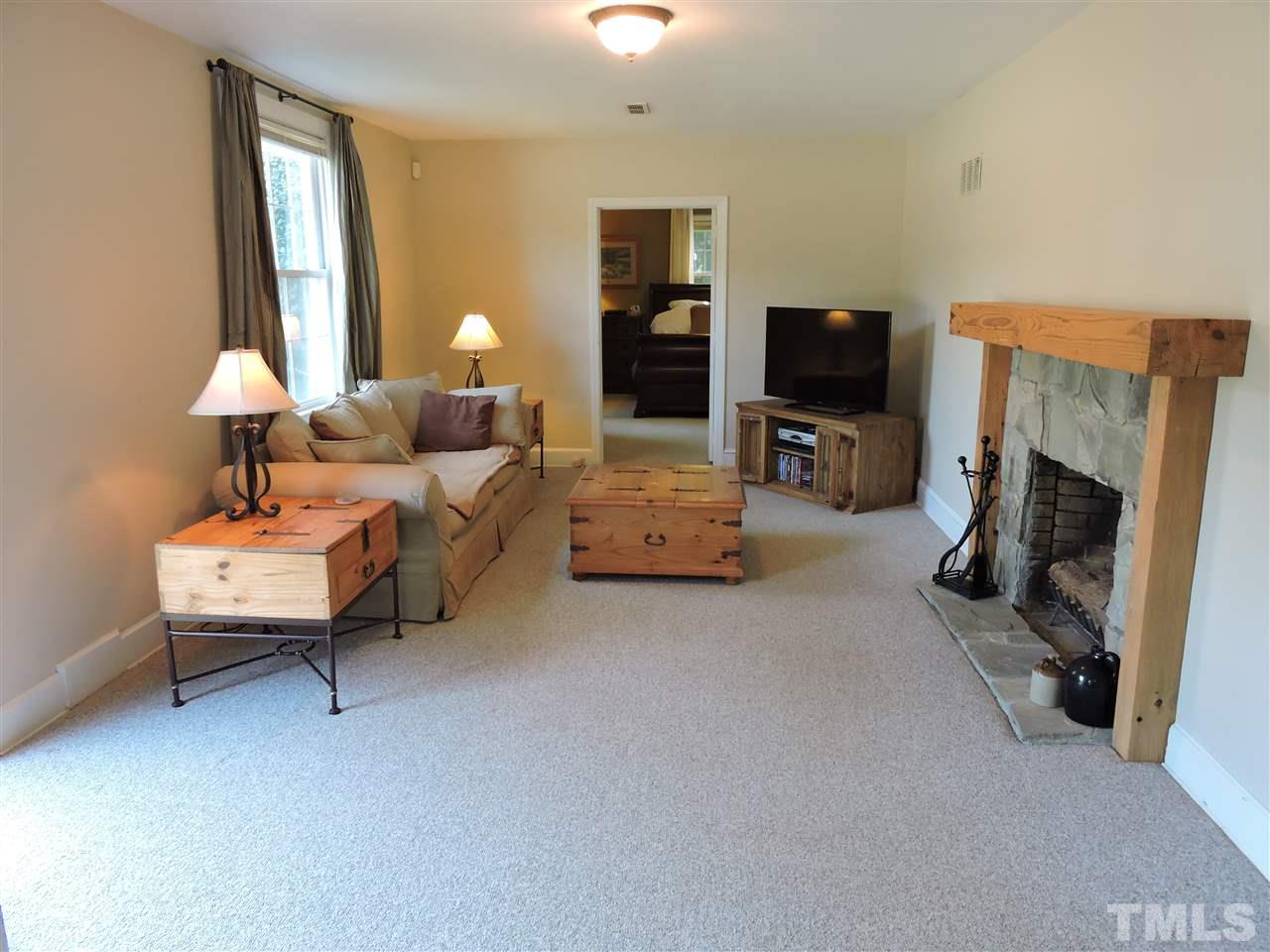 10819 North Roxboro Road Rougemont, NC 27572 - Photo 5 of 19 a living room with furniture a flat screen tv and a fireplace