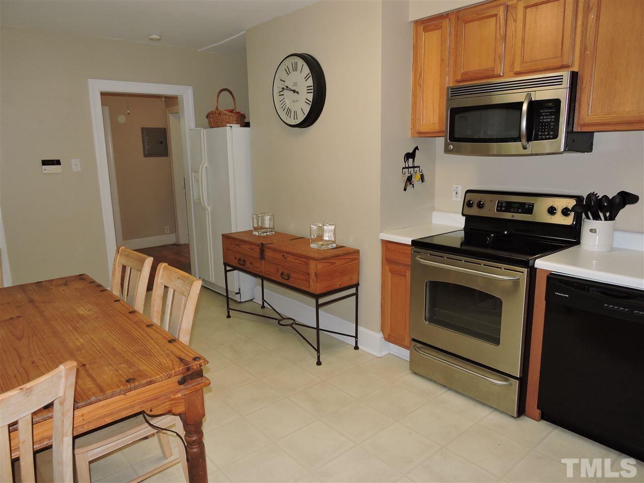 10819 North Roxboro Road Rougemont, NC 27572 - Photo 6 of 19 a kitchen with stainless steel appliances a stove a microwave and a refrigerator