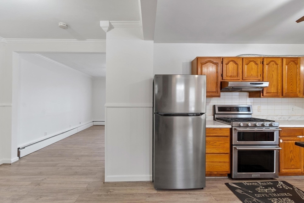 524 Merrimack Street Methuen, MA 01844 - Photo 12 of 42 a kitchen with stainless steel appliances a refrigerator stove and microwave