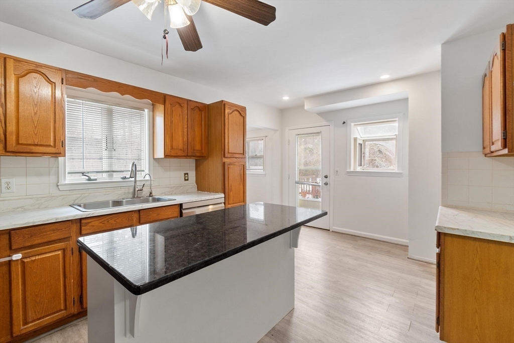524 Merrimack Street Methuen, MA 01844 - Photo 13 of 42 a kitchen with stainless steel appliances granite countertop a sink a stove and a refrigerator