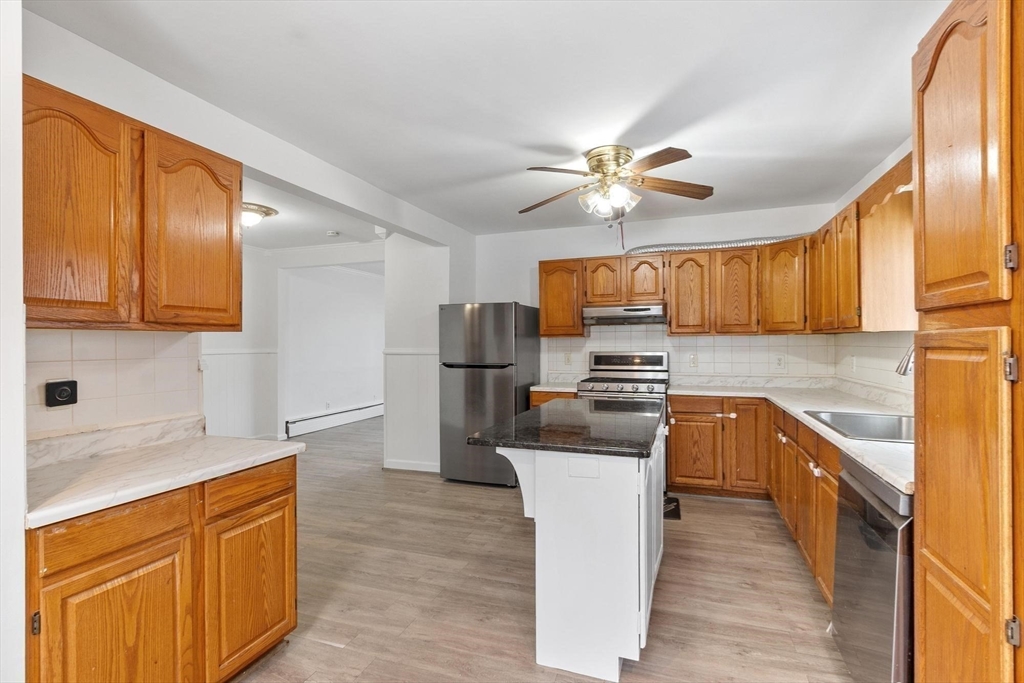 524 Merrimack Street Methuen, MA 01844 - Photo 15 of 42 a kitchen with stainless steel appliances granite countertop a sink stove and refrigerator