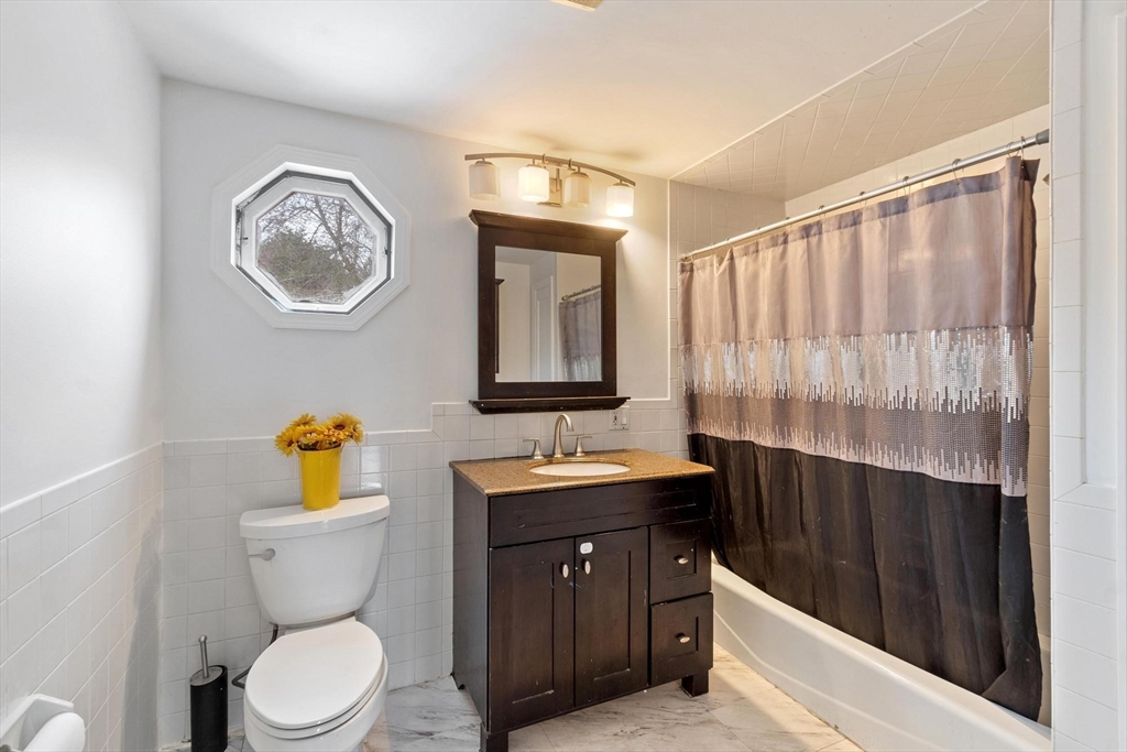 524 Merrimack Street Methuen, MA 01844 - Photo 16 of 42 a bathroom with a toilet a sink and a mirror