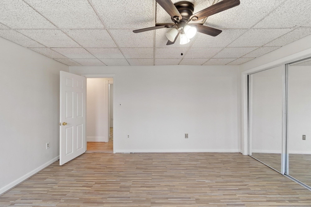524 Merrimack Street Methuen, MA 01844 - Photo 18 of 42 a view of a room with a ceiling fan and wooden floor