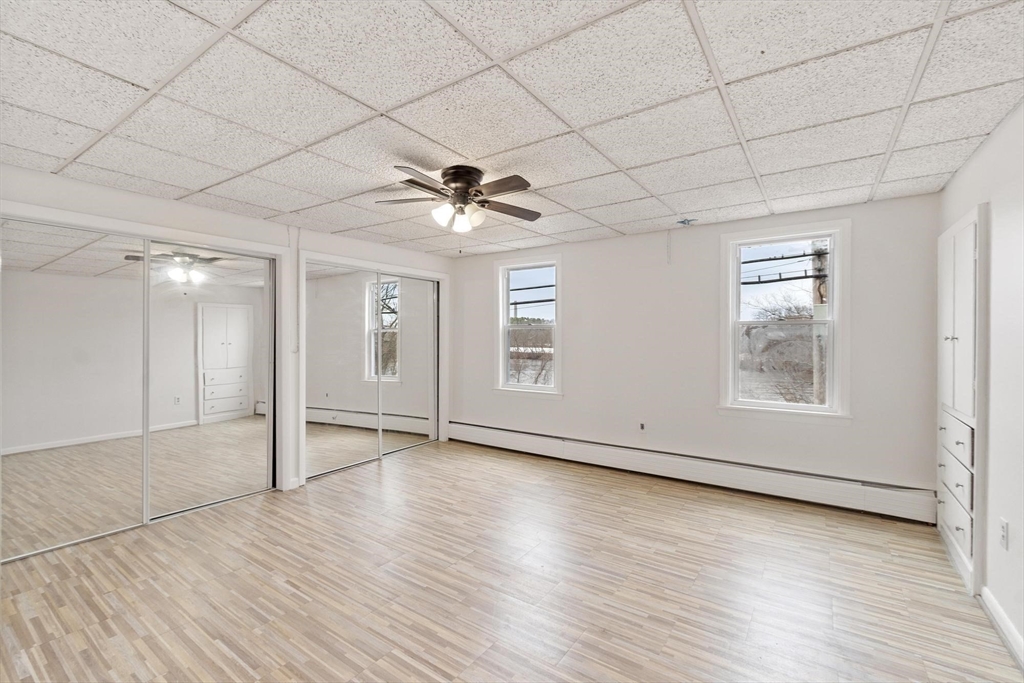 524 Merrimack Street Methuen, MA 01844 - Photo 20 of 42 an empty room with wooden floor and windows
