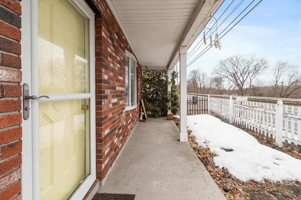 524 Merrimack Street Methuen, MA 01844 - Photo 2 of 42 a view of balcony with wooden floor and fence
