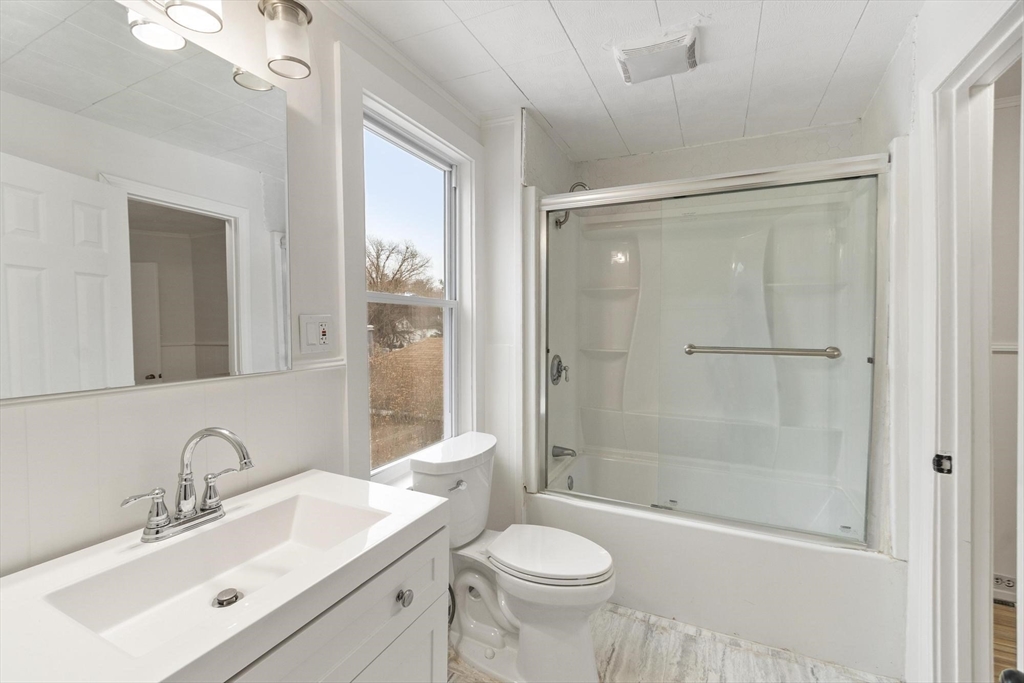 524 Merrimack Street Methuen, MA 01844 - Photo 26 of 42 a bathroom with a sink toilet a mirror and shower