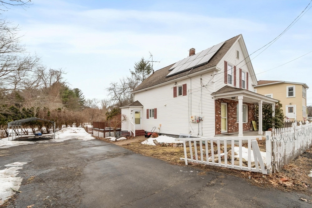 524 Merrimack Street Methuen, MA 01844 - Photo 27 of 42 a view of a white house with wooden fence