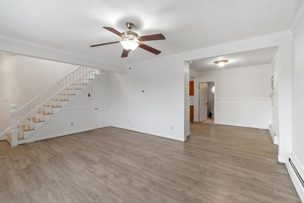 524 Merrimack Street Methuen, MA 01844 - Photo 4 of 42 an empty room with wooden floor fan and windows