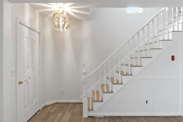a view of entryway and hall with wooden floor
