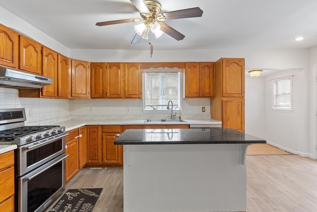 524 Merrimack Street Methuen, MA 01844 - Photo 10 of 42 a kitchen with granite countertop a sink stainless steel appliances and cabinets