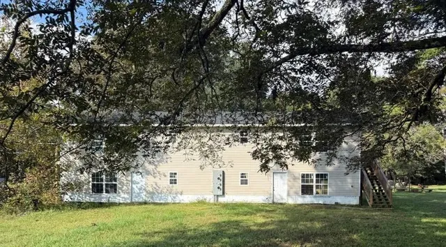 a view of a house with a yard and garage