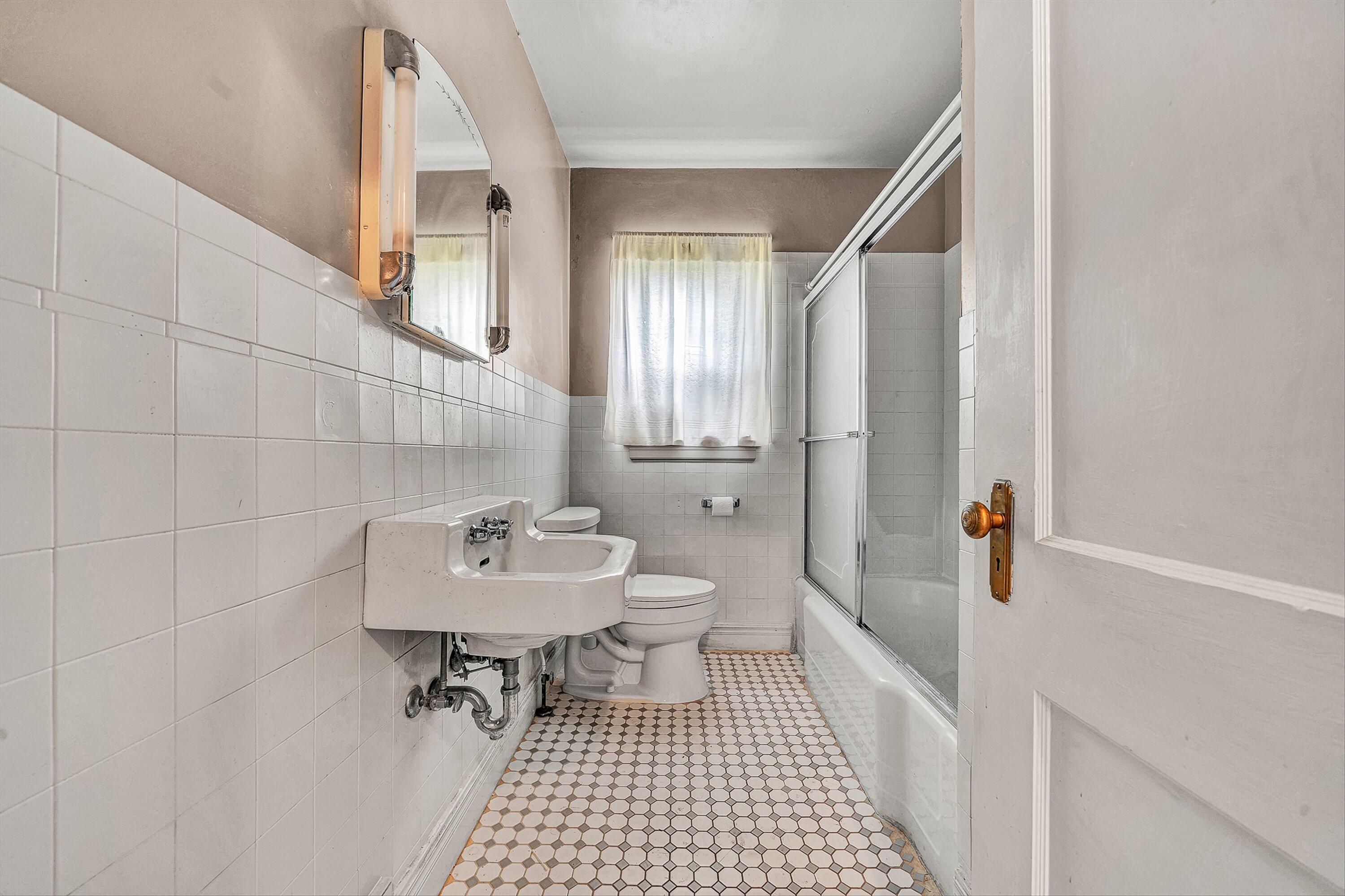 1917 Langdon Road Southwest Roanoke, VA 24015 - Photo 16 of 42 a bathroom with a sink a toilet and shower