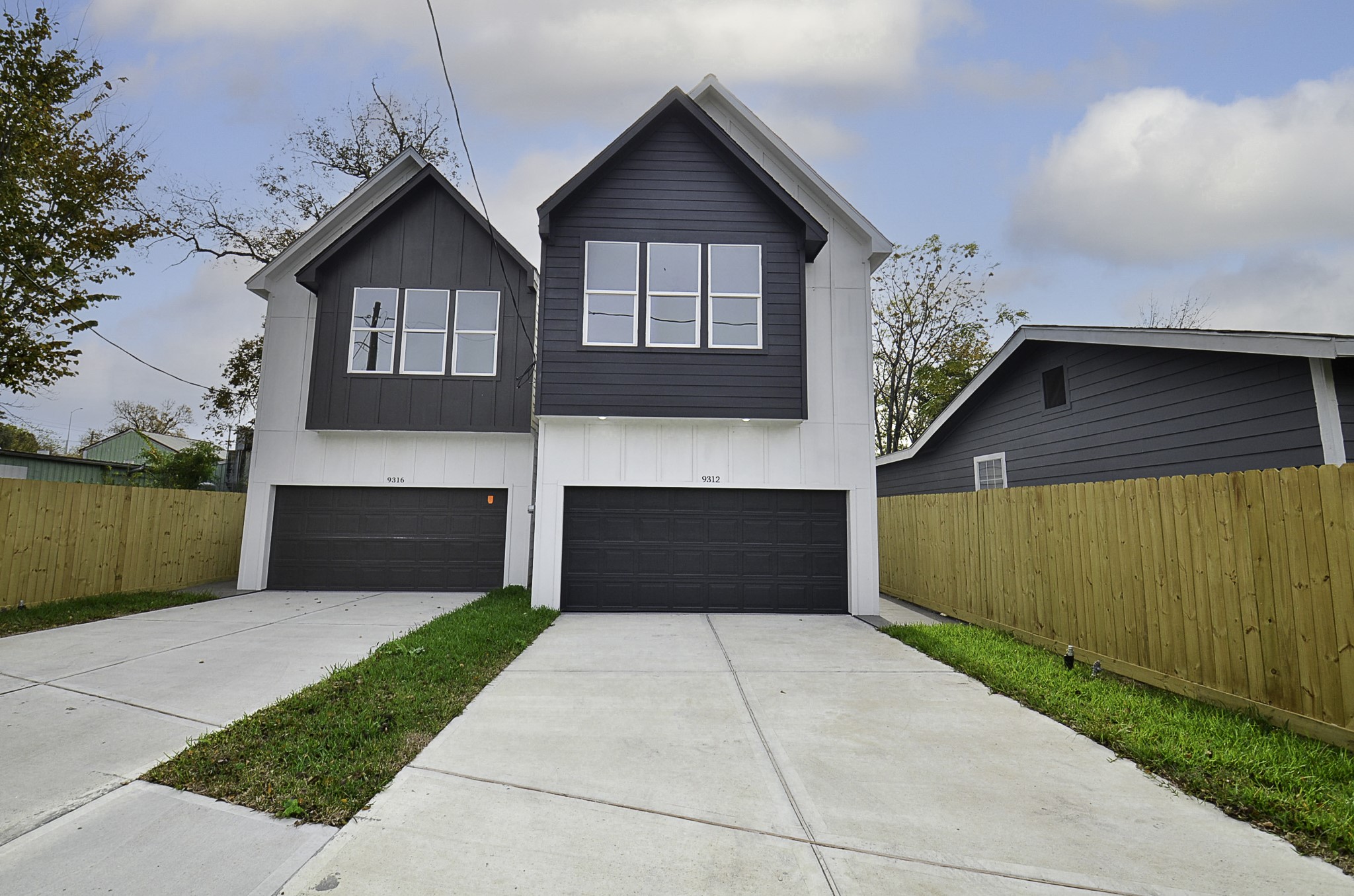9312 Waller Street Houston, TX 77012 - Photo 1 of 26 a front view of a house with a yard and garage