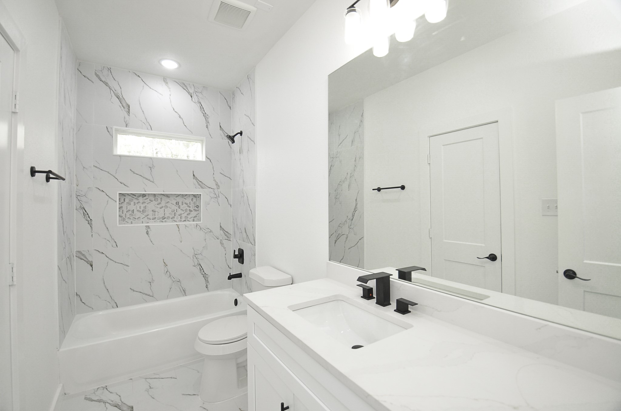 9312 Waller Street Houston, TX 77012 - Photo 13 of 26 a bathroom with a sink a toilet and shower