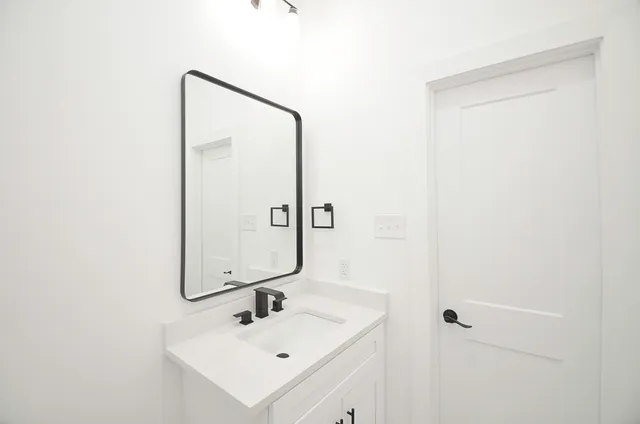 a bathroom with a sink a mirror and shower