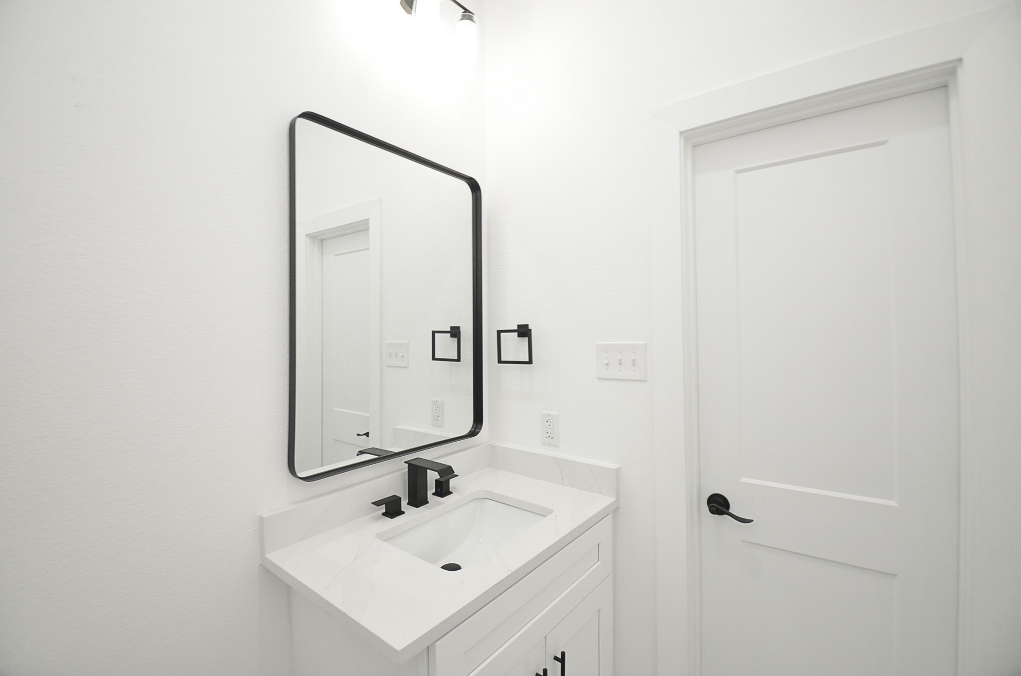 9312 Waller Street Houston, TX 77012 - Photo 14 of 26 a bathroom with a sink a mirror and shower