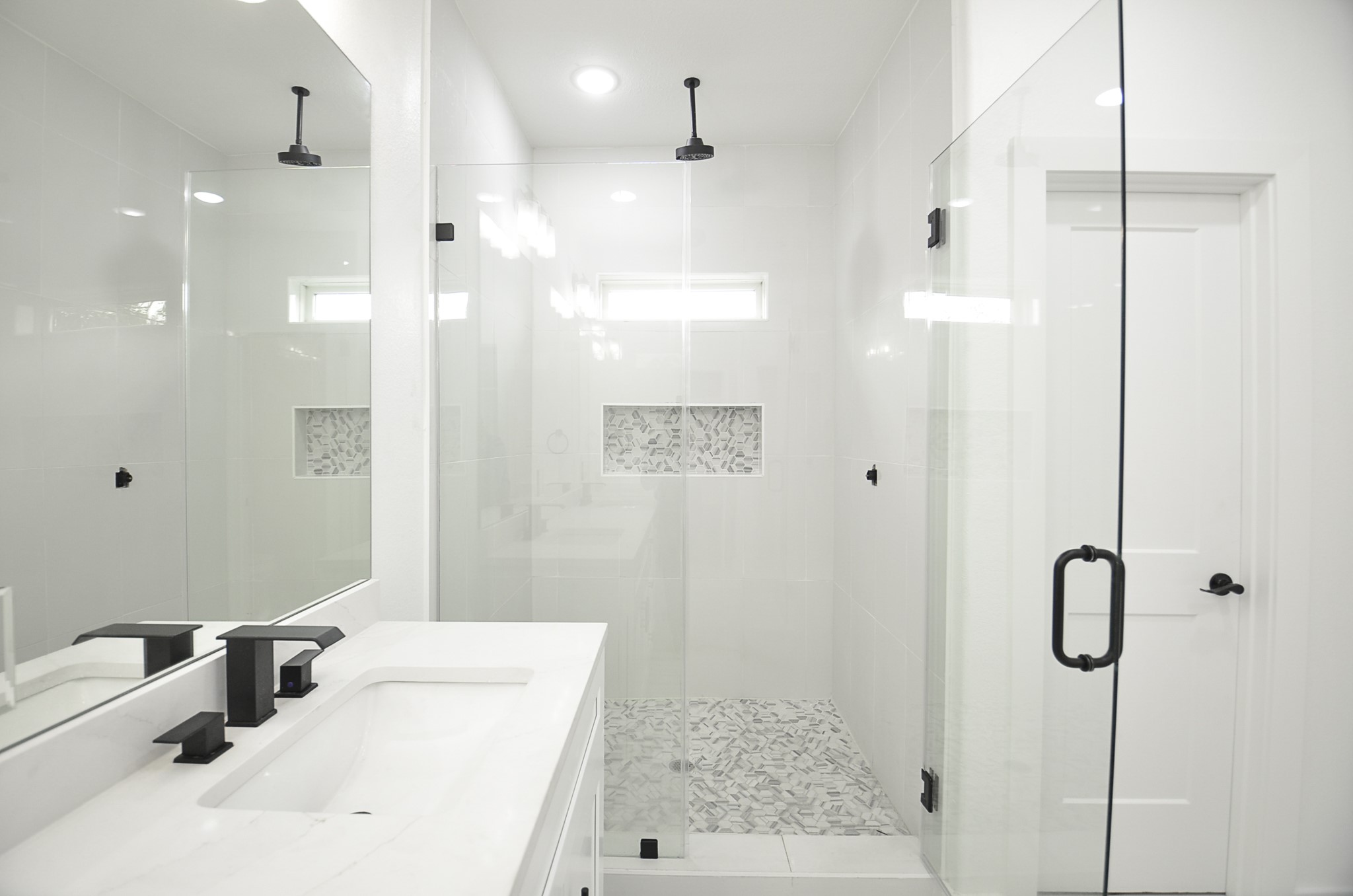 9312 Waller Street Houston, TX 77012 - Photo 20 of 26 a bathroom with a sink a shower and a mirror