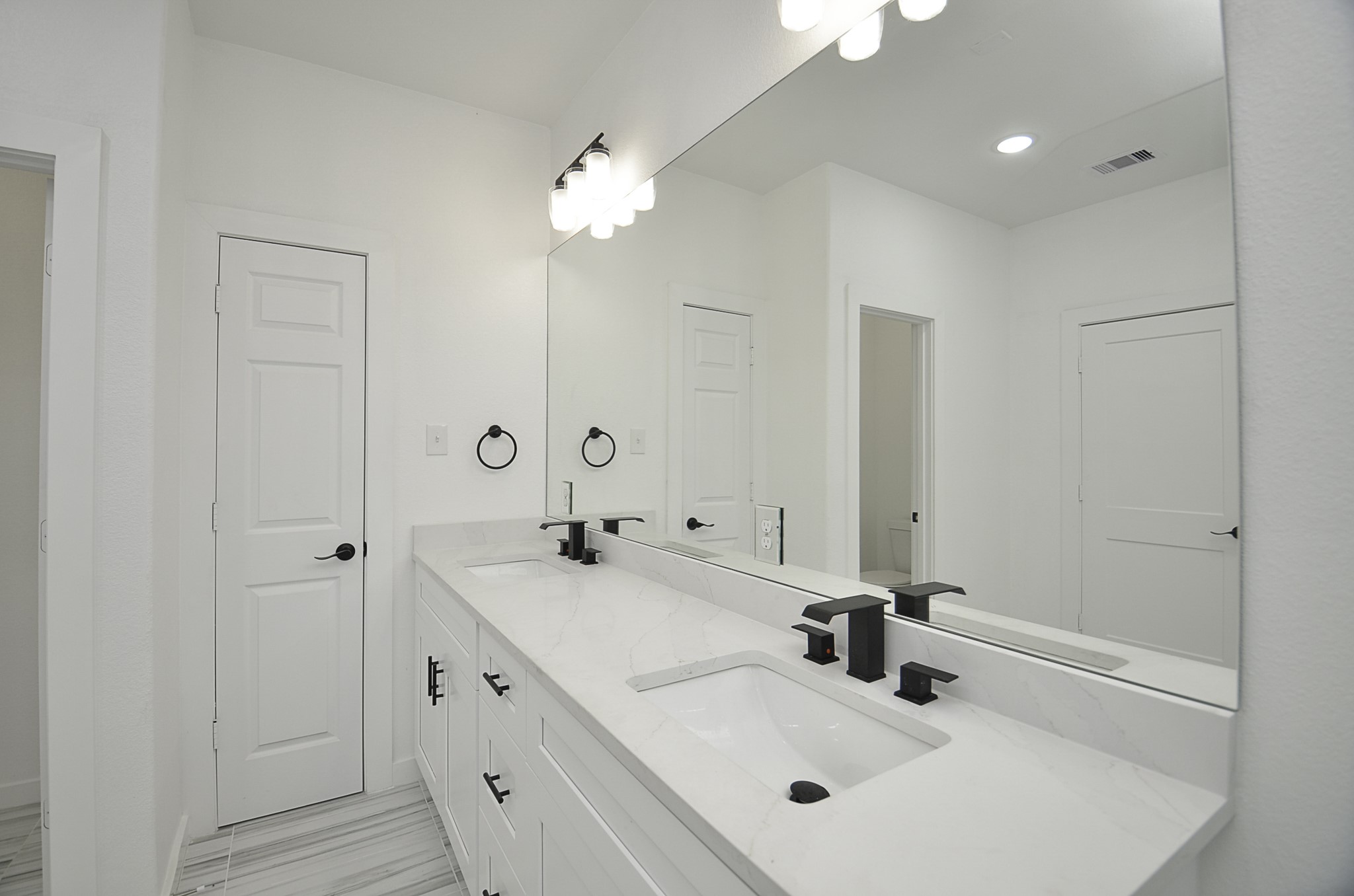 9312 Waller Street Houston, TX 77012 - Photo 21 of 26 a bathroom with double vanity sink and a mirror