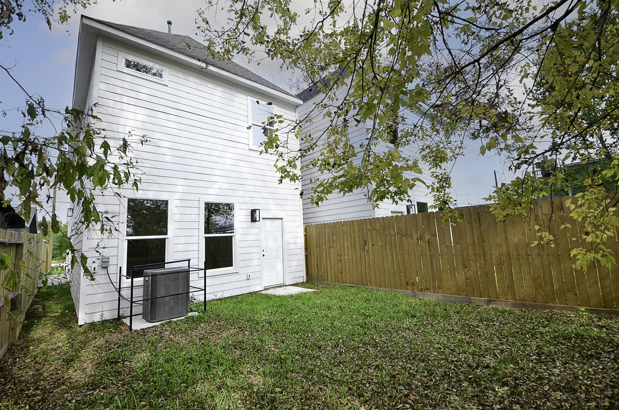 9312 Waller Street Houston, TX 77012 - Photo 25 of 26 a view of backyard with potted plants and a large tree