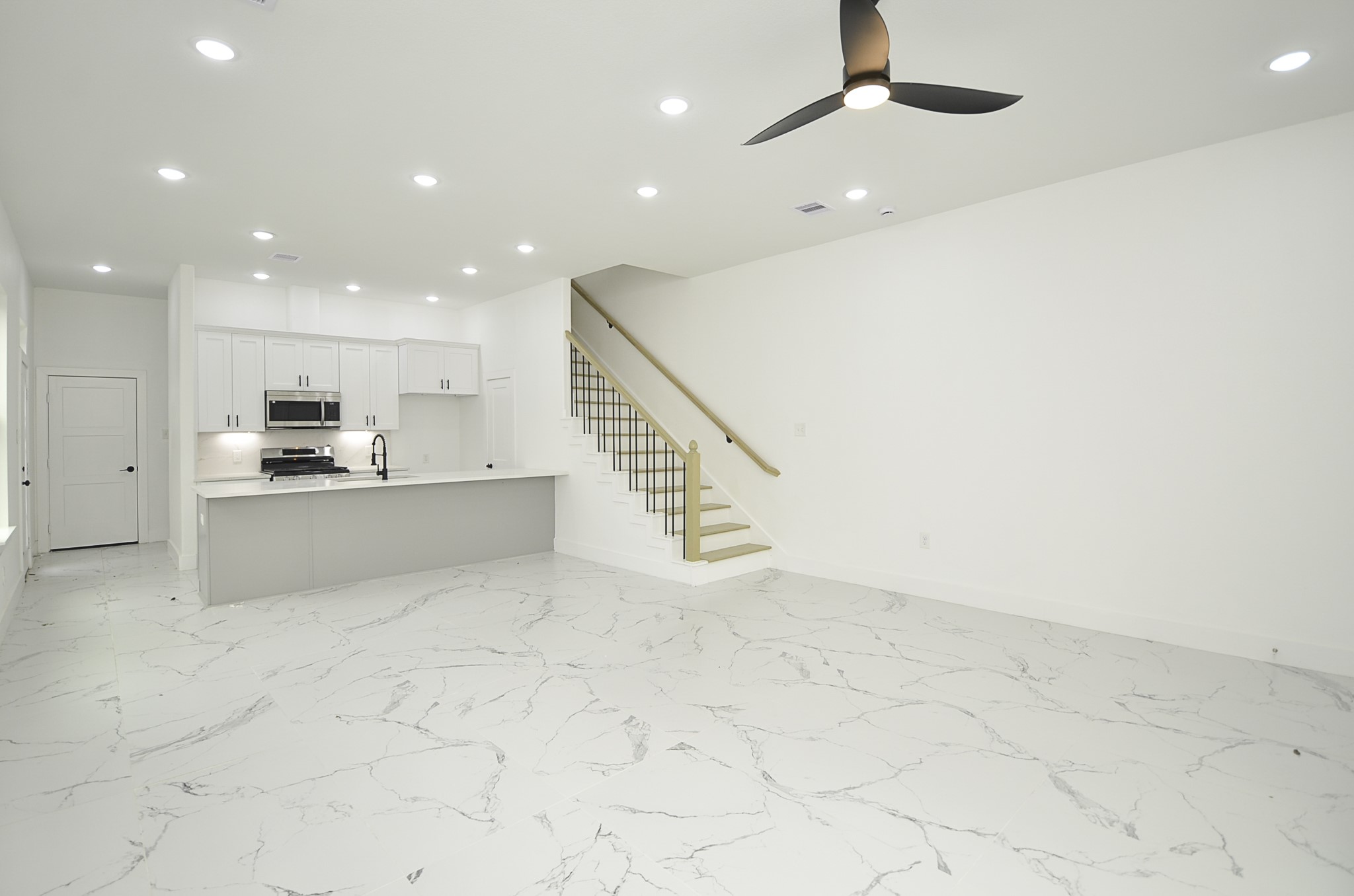 9312 Waller Street Houston, TX 77012 - Photo 4 of 26 a view of kitchen with kitchen island microwave and cabinets