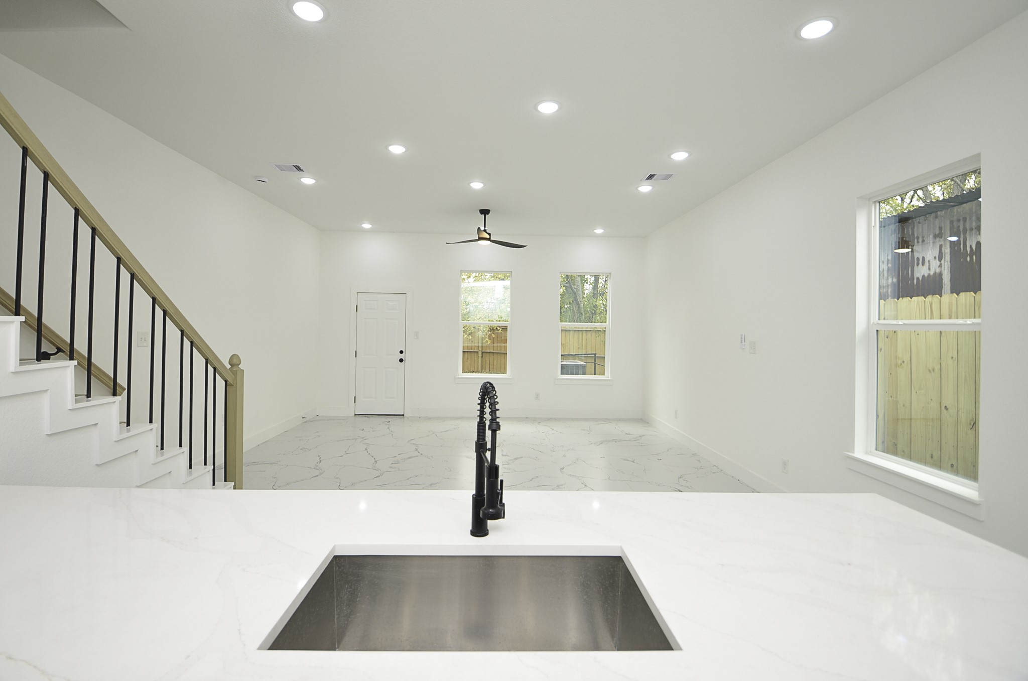 9312 Waller Street Houston, TX 77012 - Photo 9 of 26 a hallway with a large window and potted plants