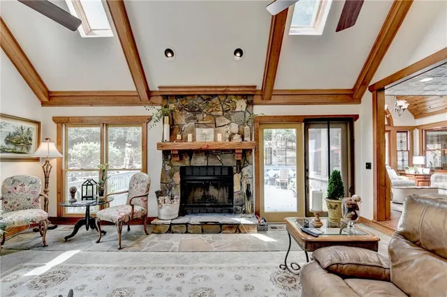 a kitchen with stainless steel appliances granite countertop a stove top oven a sink dishwasher and refrigerator with wooden floor