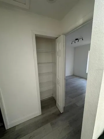 an empty room with wooden floor