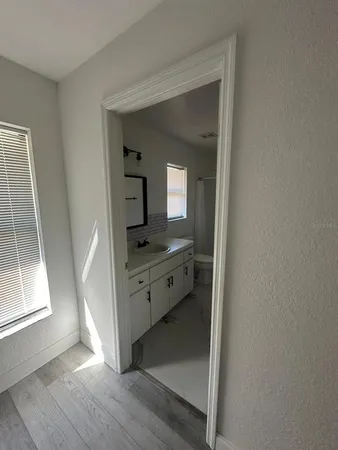a room with a mirror and a sink