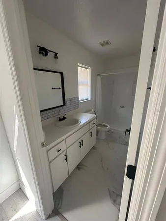 a bathroom with a sink a mirror and vanity