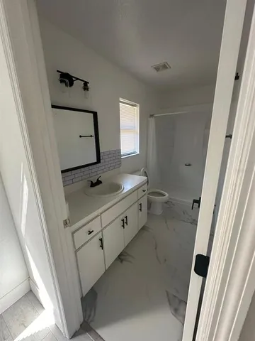 a bathroom with a sink a mirror and vanity