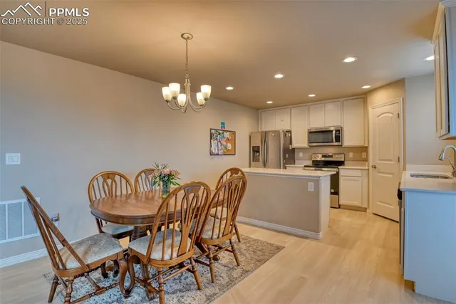 a dining room with furniture and chandelier