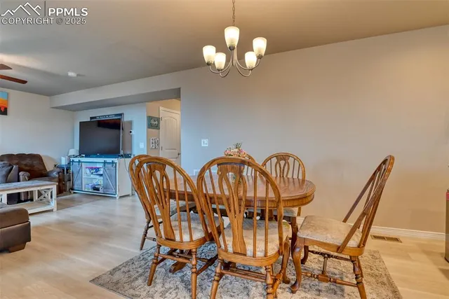 a dining room with furniture and chandelier