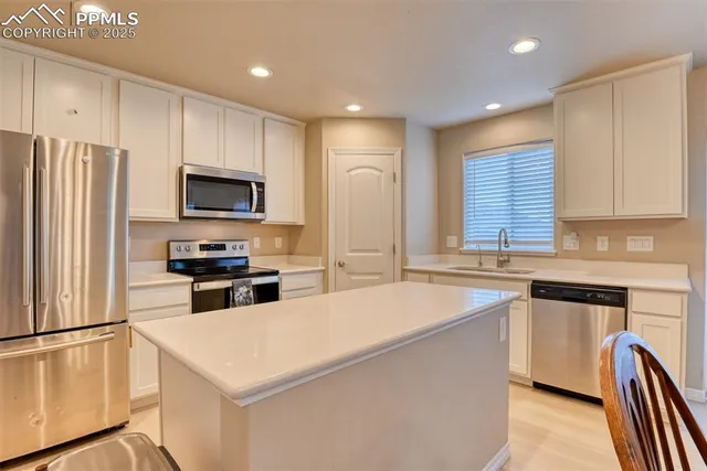a view of a dining room with furniture and a chandelier