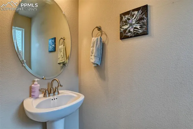a dining room with furniture a chandelier and kitchen view
