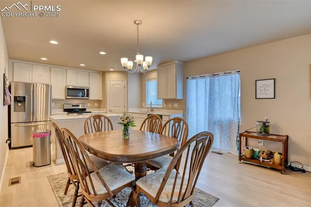 a kitchen with cabinets and refrigerator