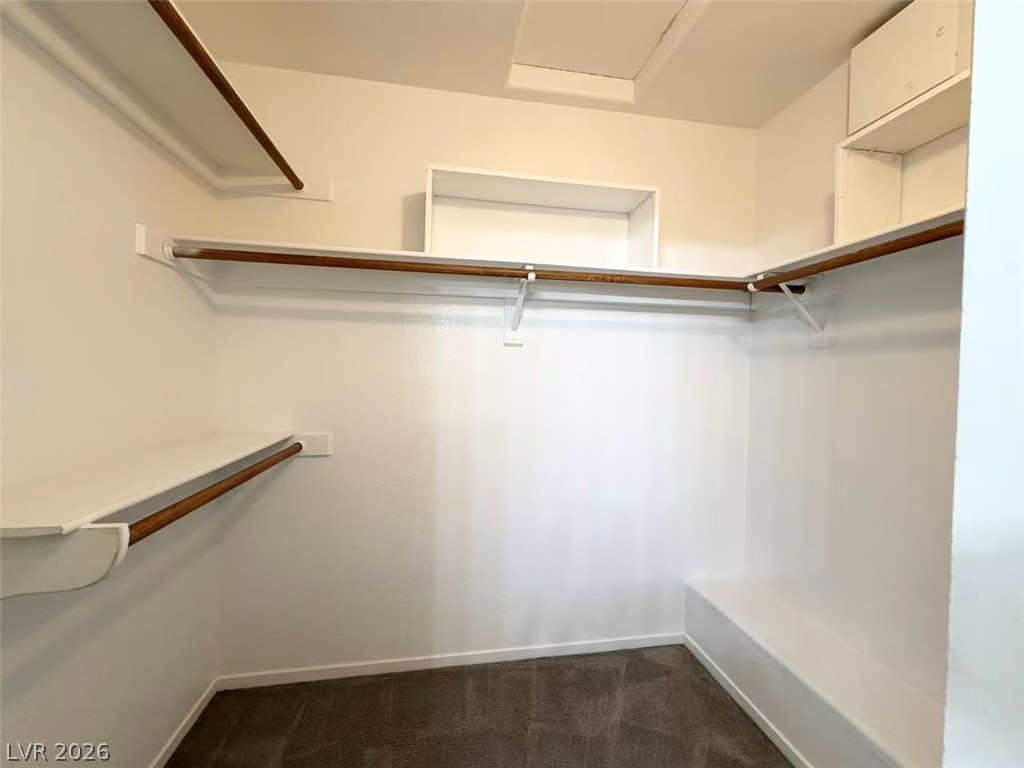 8620 Magnolia Ridge Avenue Las Vegas, NV 89134 - Photo 11 of 15 An organized wardrobe solution with built-in shelving and ample hanging space.